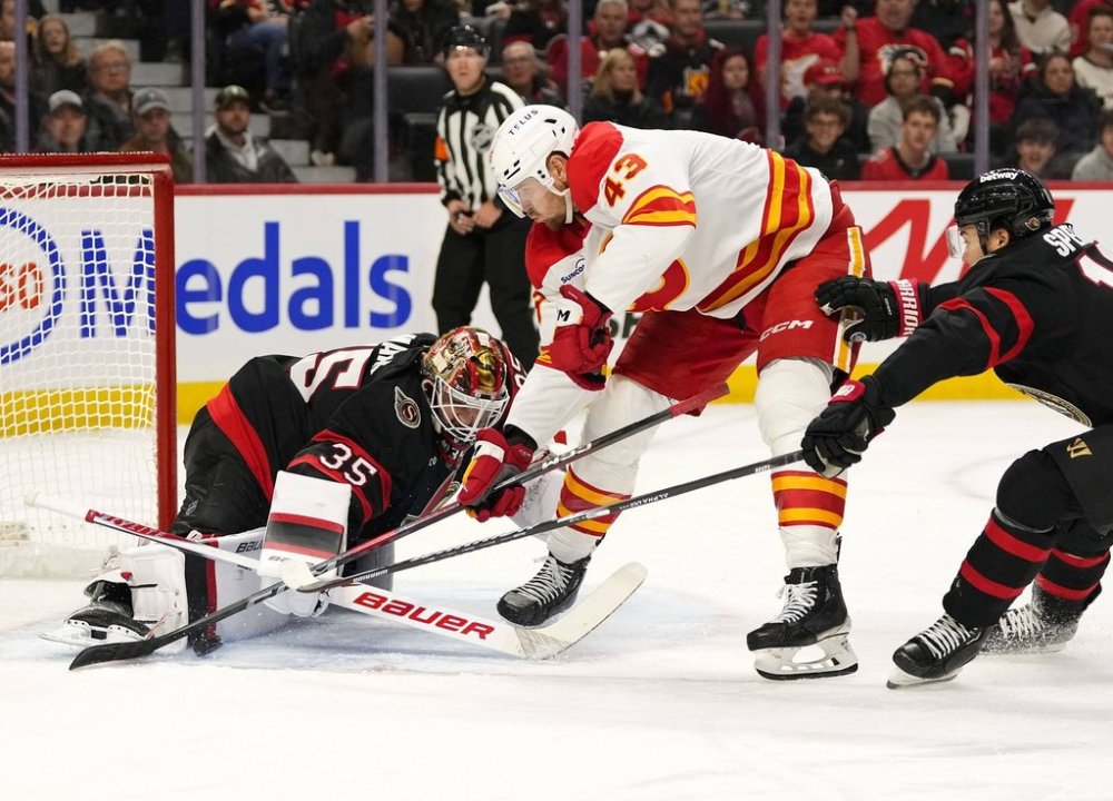 Ottawa Senators goaltender Linus Ullmark (35) makes a save on Calgary Flames' Adam Klapka (43) as Senators' Jordan Spence (10) defends, during first period NHL hockey action in Ottawa, on Thursday, Oct. 30, 2025. THE CANADIAN PRESS/Justin Tang