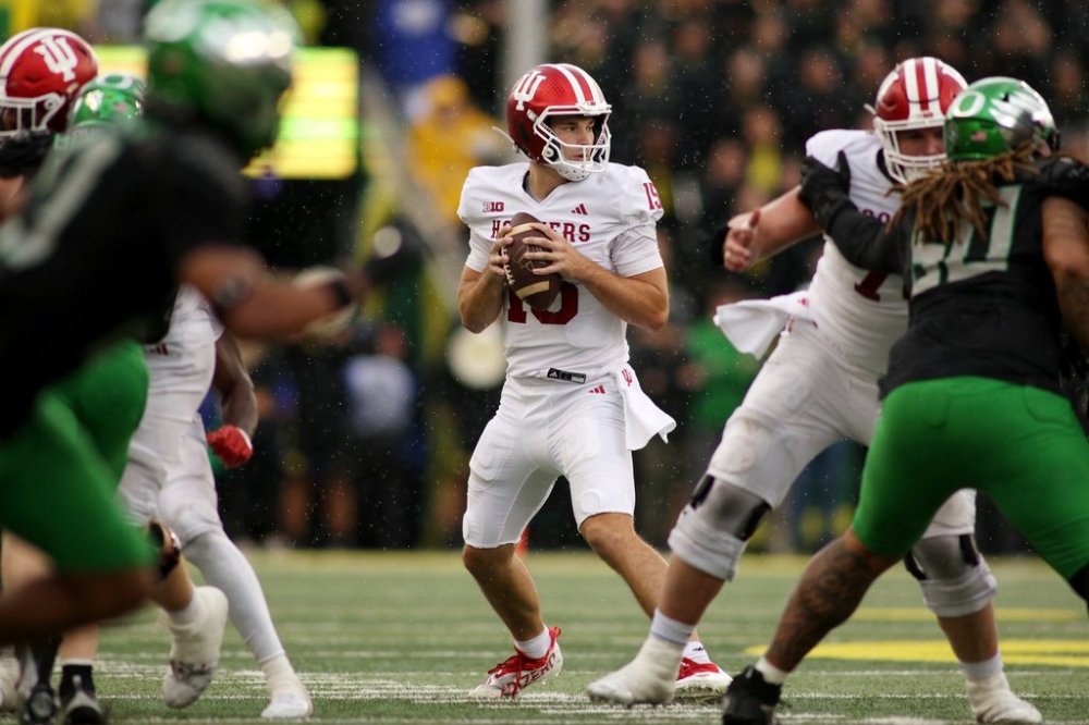 Indiana quarterback Fernando Mendoza (15) looks for an opening in the Oregon defense during the second half of an NCAA college football game, Saturday, Oct. 11, 2025, in Eugene, Ore. (AP Photo/Lydia Ely)