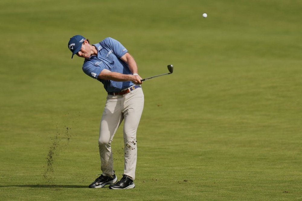 Max Greyserman, of the U.S., hits from the fairway on the first hole during the fourth round of the Baycurrent Classic golf tournament at the Yokohama Country Club in Yokohama, near Tokyo, Sunday, Oct. 12, 2025. (AP Photo/Hiro Komae)