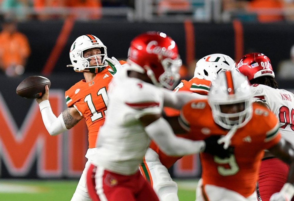 Miami quarterback Carson Beck (11) throws the ball during the first half of an NCAA college football game against Louisville, Friday, Oct. 17, 2025, in Miami Gardens, Fla. (AP Photo/Michael Laughlin)