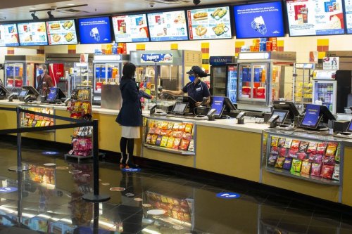 A movie goer stands at the concessions kiosk in the lobby of a Cineplex theatre in Toronto,  on Tuesday, Oct. 6, 2020. THE CANADIAN PRESS/Chris Young