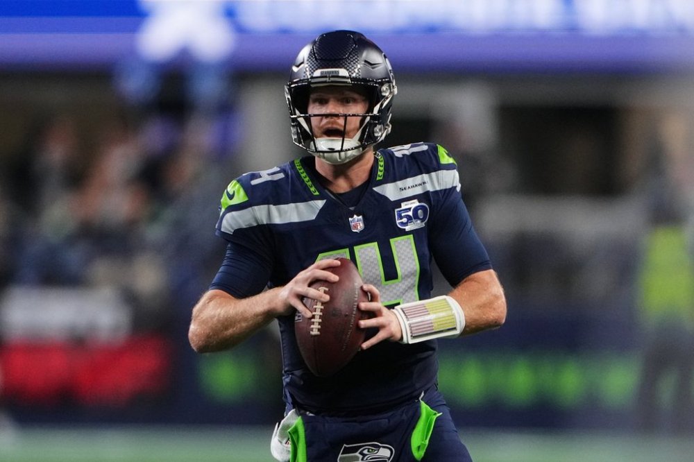 Seattle Seahawks quarterback Sam Darnold (14) scrambles in the first half of an NFL football game against the Houston Texans Monday, Oct. 20, 2025, in Seattle. (AP Photo/Lindsey Wasson)