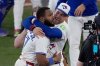 Toronto Blue Jays Vladimir Guerrero Jr. and George Springer, right, celebrate after Game 7 of baseball's American League Championship Series against the Seattle Mariners, Monday, Oct. 20, 2025, in Toronto. (AP Photo/David J. Phillip)