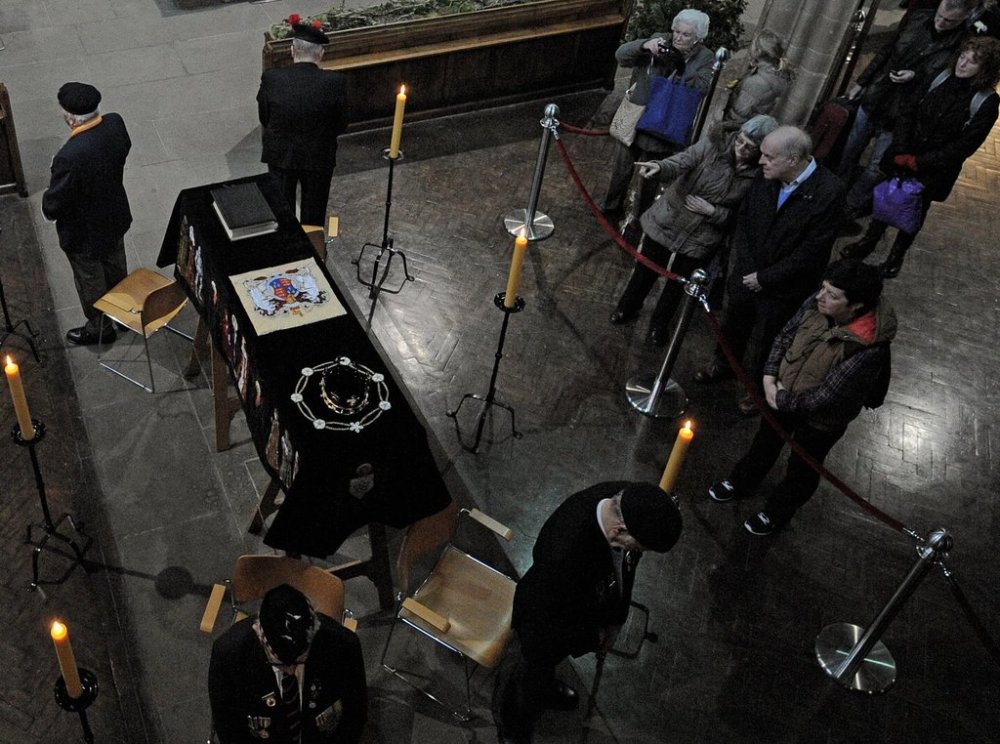 FILE - In this Monday, March 23, 2015 file photo, members of the public view the coffin of Richard III as it lies in repose inside Leicester Cathedral, Leicester, England. (AP Photo/Rui Vieira, File)