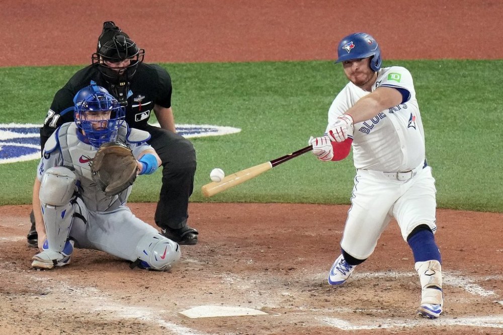 Toronto Blue Jays catcher Alejandro Kirk (30) hits a single during seventh inning Game 7 World Series playoff MLB baseball action against the Los Angeles Dodgers, in Toronto, Saturday, Nov. 1, 2025. THE CANADIAN PRESS/Chris Young