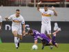 Fiorentina's Hans Nicolussi Caviglia, center, fights for the ball with Lecce's Nikola Stulic and Medon Berisha during the Italian Serie A soccer match between Fiorentina and Lecce in Florence, Italy, Sunday, Nov. 2, 2025. (Marco Bucco/LaPresse via AP)