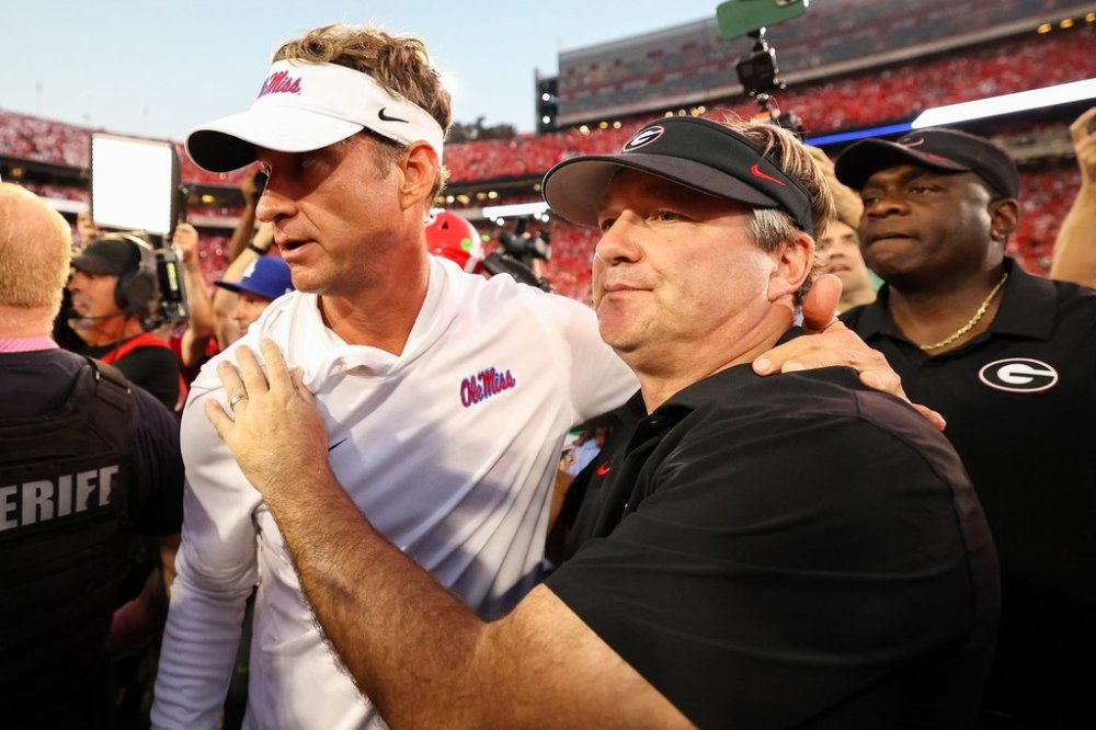 Mississippi head coach Lane Kiffin, left, and Georgia head coach Kirby Smart, right, embrace at midfield after an NCAA college football game, Saturday, Oct. 18, 2025, in Athens, Ga. (AP Photo/Colin Hubbard)