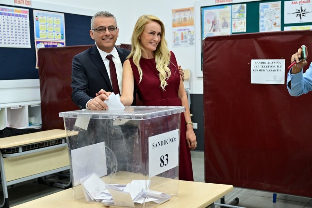 Turkish Cypriot candidate Tufan Erhurman and his wife Nilden Bektas cast their ballot at a polling station during the Turkish Cypriots election for a new leader in the Turkish occupied area in the north part of the divided capital Nicosia, Cyprus, Sunday, Oct. 19, 2025. (AP Photo/Nedim Enginsoy)
