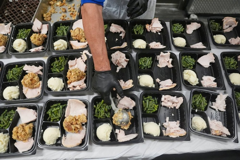 A volunteer prepares meals at the Philabundance Community Kitchen in Philadelphia, Thursday, Oct. 30, 2025. (AP Photo/Matt Rourke)