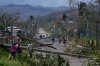 Residents walk through Lacovia Tombstone, Jamaica, in the aftermath of Hurricane Melissa, Wednesday, Oct. 29, 2025. (AP Photo/Matias Delacroix)