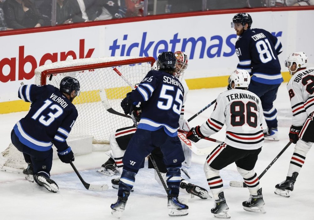 Winnipeg Jets' Kyle Connor (81) scores on Chicago Blackhawks goaltender Spencer Knight (30) during third period NHL action in Winnipeg on Thursday, October 30, 2025. THE CANADIAN PRESS/John Woods