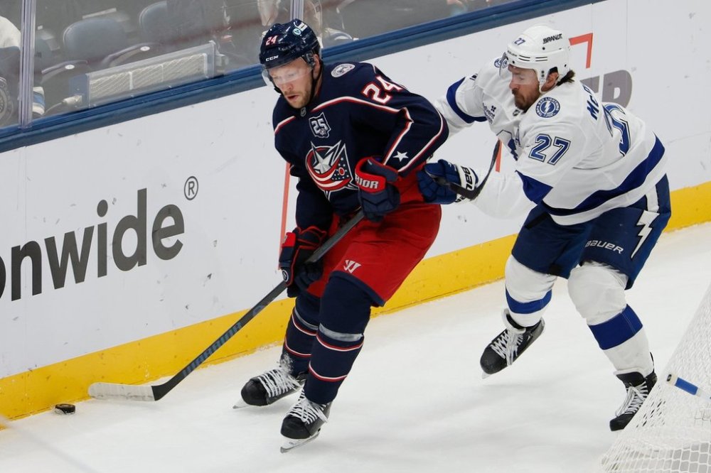 Columbus Blue Jackets' Mathieu Olivier, left, controls the puck as Tampa Bay Lightning's Ryan McDonagh defends during the second period of an NHL hockey game Saturday, Oct. 18, 2025, in Columbus, Ohio. (AP Photo/Jay LaPrete)