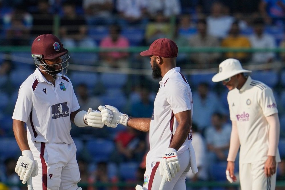 West Indies' John Campbell and Shai Hope give the fist touch after scoring runs on the third day of the second cricket test match between India and West Indies at the Arun Jaitley Stadium in New Delhi, India, Sunday, Oct.12, 2025. (AP Photo/Manish Swarup)