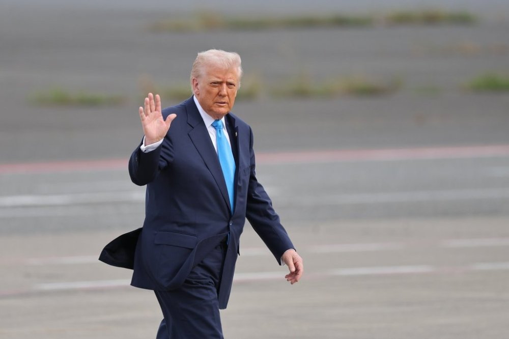 U.S. President Donald Trump walks towards Air Force One at Haneda Airport in Tokyo for his departure to South Korea, Wednesday, Oct. 29, 2025. (Kim Kyung-Hoon/Pool Photo via AP)