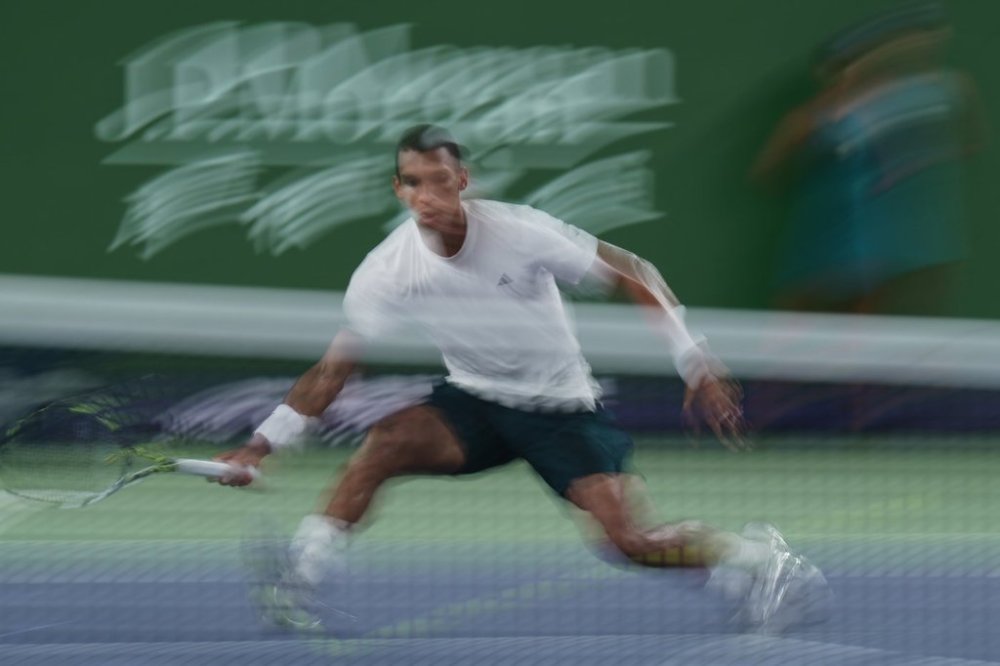 Felix Auger-Aliassime of Canada plays a forehand return to Lorenzo Musetti of Italy during a men's singles match of the Shanghai Masters tennis tournament at Qizhong Forest Sports City Tennis Center, in Shanghai, China, Wednesday, Oct. 8, 2025. (AP Photo/Andy Wong)