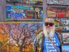 Pike Place Market vendor Daniel Fleming stands in front of his table filled with Seattle-themed digital artwork in Seattle, on Thursday, Oct. 16, 2025. THE CANADIAN PRESS/Darryl Greer
