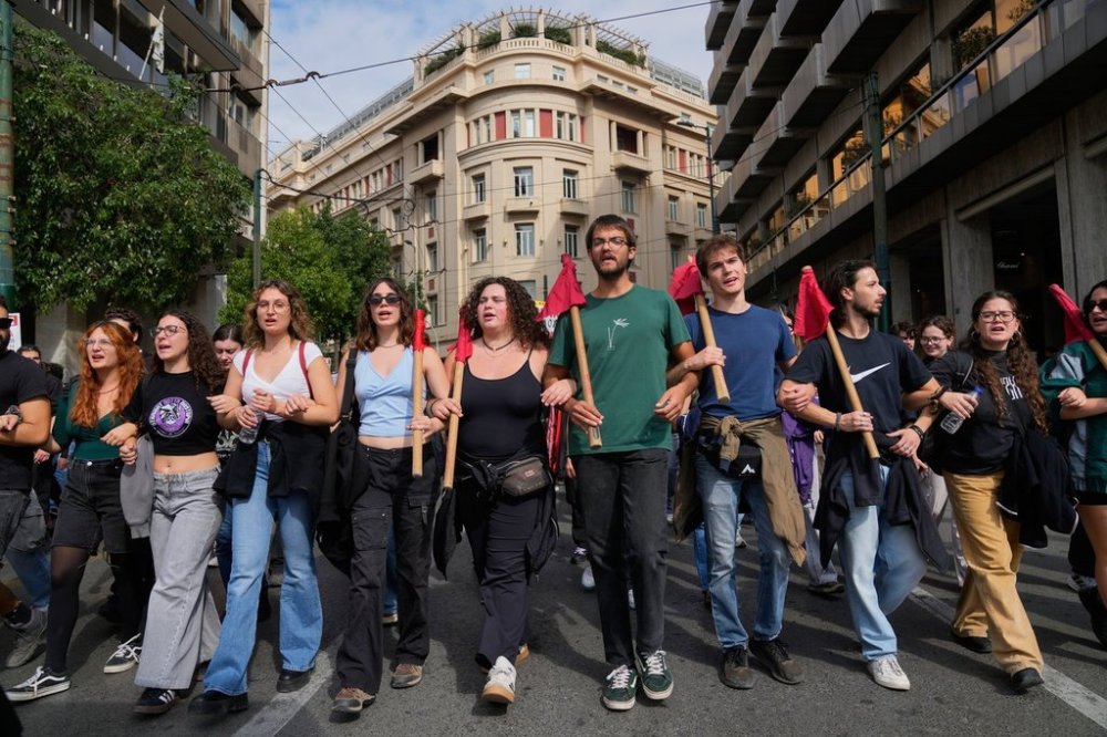 Protesters take part in a nationwide 24-hour strike in Athens, Greece, Tuesday, Oct. 14, 2025, as labor unions demand higher wages and the withdrawal of a bill changing work hours. (AP Photo/Petros Giannakouris)