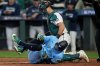 Toronto Blue Jays' George Springer falls after being hit by a pitch against the Seattle Mariners during the seventh inning in Game 5 of baseball's American League Championship Series, Friday, Oct. 17, 2025, in Seattle. (AP Photo/Abbie Parr)