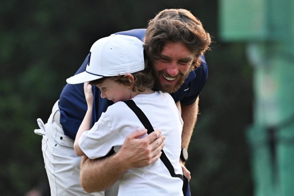 Tommy Fleetwood of England hugs his son Frankie after wining the DP World Tour Championship golf tournament in New Delhi, India, Sunday, Oct.19, 2025. (AP Photo/Dharam Diwakar)