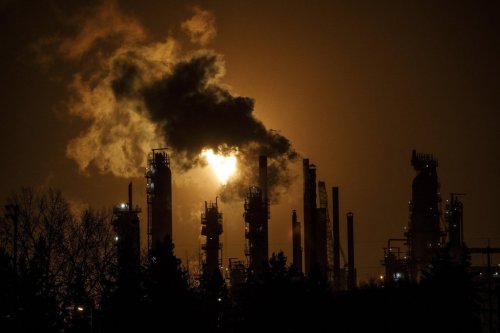 A flare stack lights the sky from a refinery in Edmonton, on Dec. 28, 2018. THE CANADIAN PRESS/Jason Franson