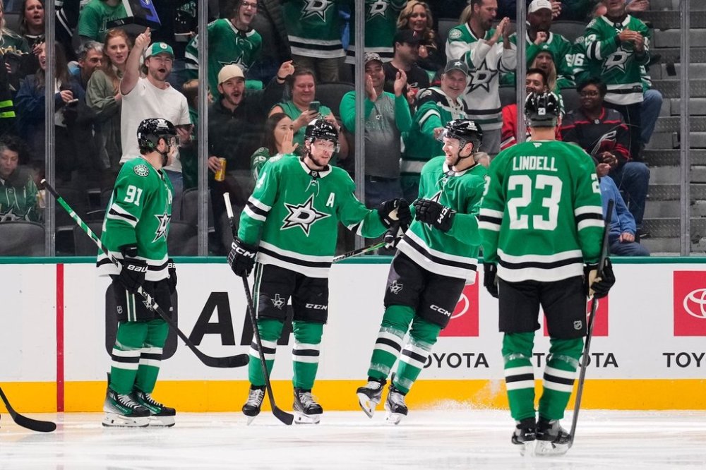 Dallas Stars' Tyler Seguin (91), Miro Heiskanen, second from left, Mikko Rantanen, second from right, and Esa Lindell (23) celebrate a goal scored by Heiskanen in the second period of an NHL hockey game against the Carolina Hurricanes Saturday, Oct. 25, 2025, in Dallas. (AP Photo/Tony Gutierrez)