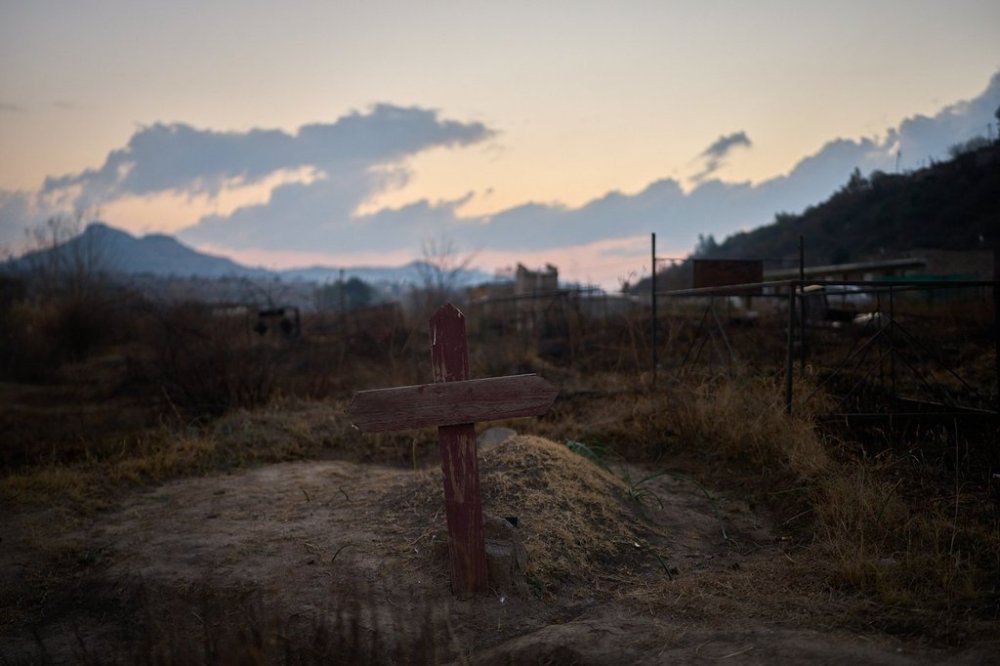 A cross is seen at a cemetery where hundreds of people who died of AIDS are buried in Maseru, Lesotho, July 20, 2025. (AP Photo/Bram Janssen)