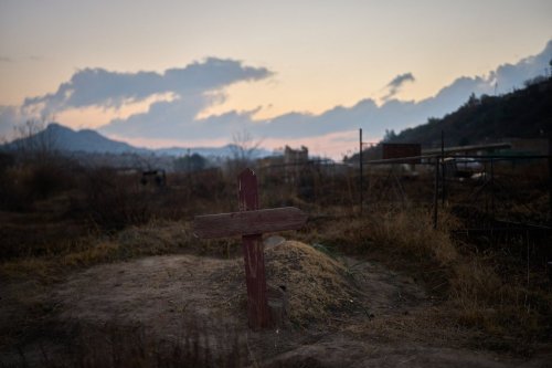 A cross is seen at a cemetery where hundreds of people who died of AIDS are buried in Maseru, Lesotho, July 20, 2025. (AP Photo/Bram Janssen)