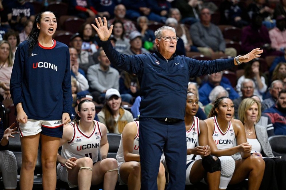 UConn head coach Geno Auriemma gestures as player Caroline Ducharme, left, calls out to their team in the first half of an exhibition NCAA college basketball game against Boston College, Monday, Oct. 13, 2025, in Uncasville, Conn. (AP Photo/Jessica Hill)