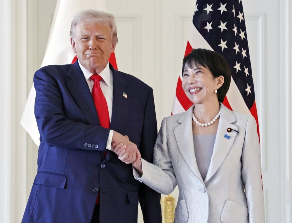 President Donald Trump, left, and Japanese Prime Minister Sanae Takaichi shake hands before their summit talk at Akasaka Palace in Tokyo, Tuesday, Oct. 28, 2025. (Kyodo News via AP)