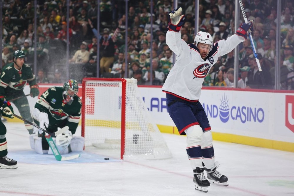 Columbus Blue Jackets left wing Miles Wood (11) scores a goal while Minnesota Wild defenseman Brock Faber (7) and Minnesota Wild goaltender Filip Gustavsson (32) defend during the first period of an NHL hockey game Saturday, Oct. 11, 2025, in St. Paul, Minn. (AP Photo/Adam Bettcher)