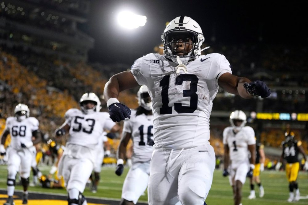 Penn State running back Kaytron Allen (13) celebrates after a touchdown run in the second half of an NCAA college football game against Iowa, Saturday, Oct. 18, 2025, in Iowa City, Iowa. (AP Photo/Charlie Neibergall)