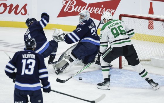 Dallas Stars' Mikko Rantanen (96) scores on Winnipeg Jets goaltender Connor Hellebuyck (37) in Winnipeg on Thursday. (John Woods / The Canadian Press files)