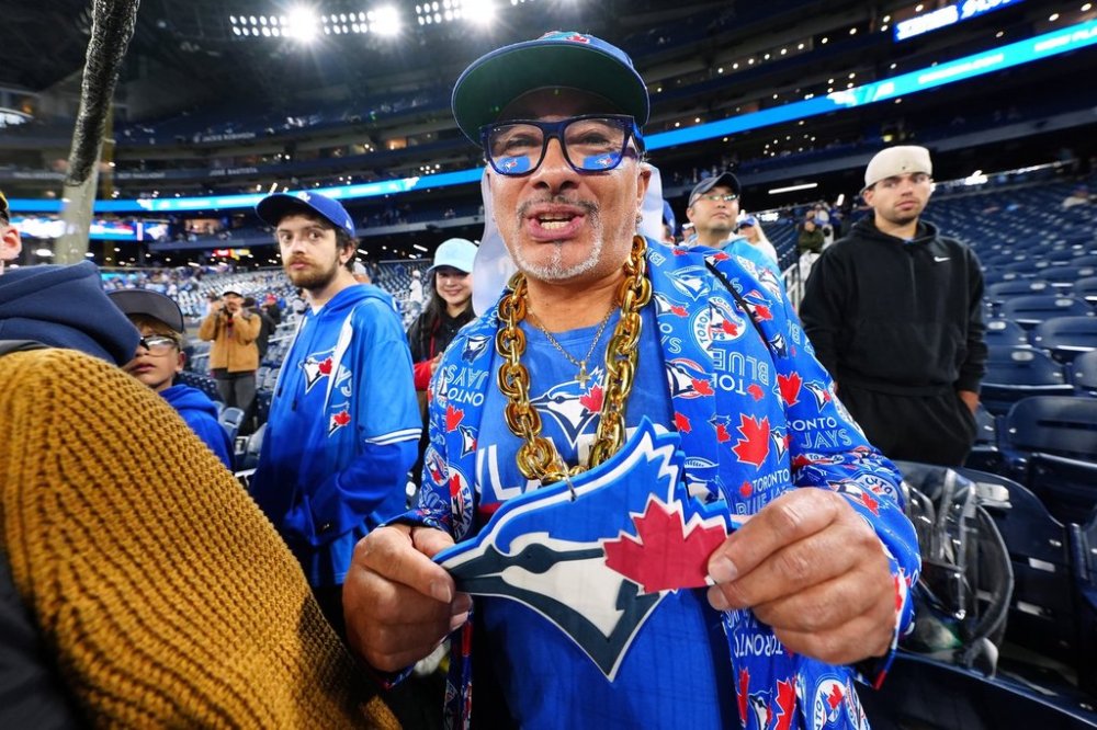 A Toronto Blue Jays fan cheers ahead of first inning Game 2 World Series playoff MLB baseball action against the Los Angeles Dodgers in Toronto on Saturday, Oct. 25, 2025. THE CANADIAN PRESS/Frank Gunn