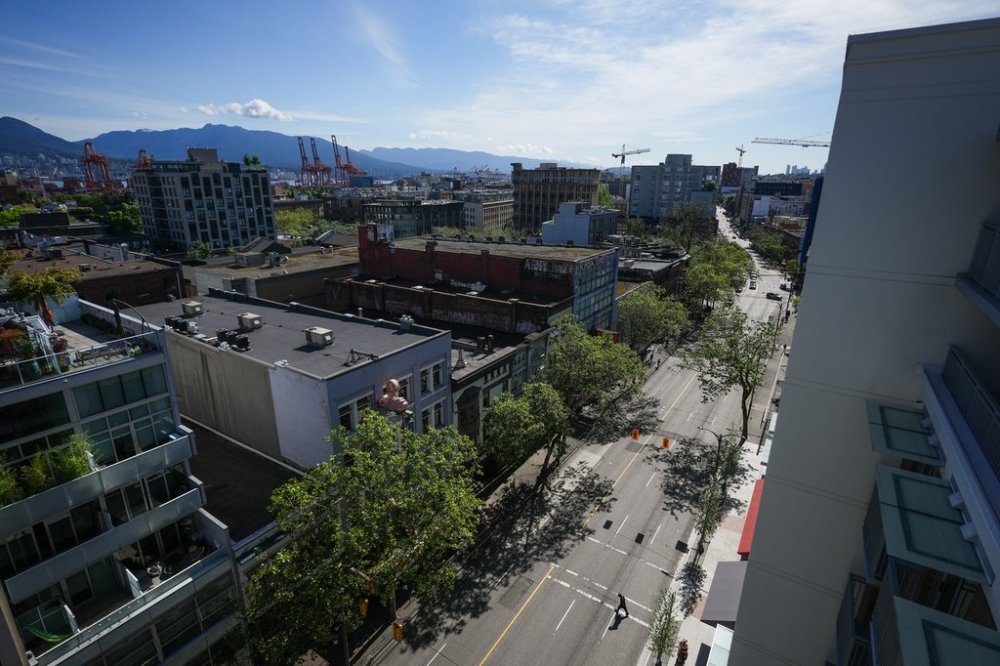 A pedestrian crosses East Hastings Street in the Downtown Eastside of Vancouver, on Thursday, June 13, 2024. THE CANADIAN PRESS/Darryl Dyck