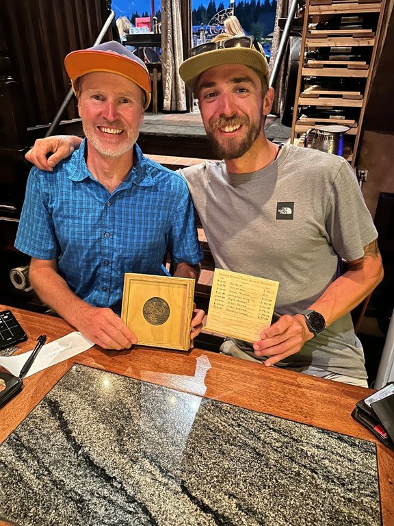 Michelino Sunseri, right, accepts a ceremonial belt buckle from Andy Anderson on Sept. 6, 2024, in Truckee, Calif., after breaking Anderson's record time for running up and down Grand Teton mountain in Grand Teton National Park in Wyoming a few days earlier. (Michelino Sunseri via AP)