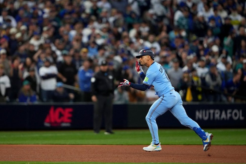Toronto Blue Jays' Andrés Giménez celebrates his two run home run against the Seattle Marinersduring the third inning in Game 4 of baseball's American League Championship Series, Thursday, Oct. 16, 2025, in Seattle. (AP Photo/Lindsey Wasson)