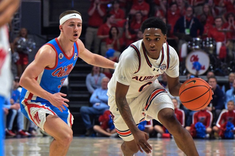 FILE - Auburn guard Tahaad Pettiford (0) is defended by Mississippi guard Sean Pedulla (3) during the first half of an NCAA college basketball game in Oxford, Miss., Feb. 1, 2025. (AP Photo/Bruce Newman, File)