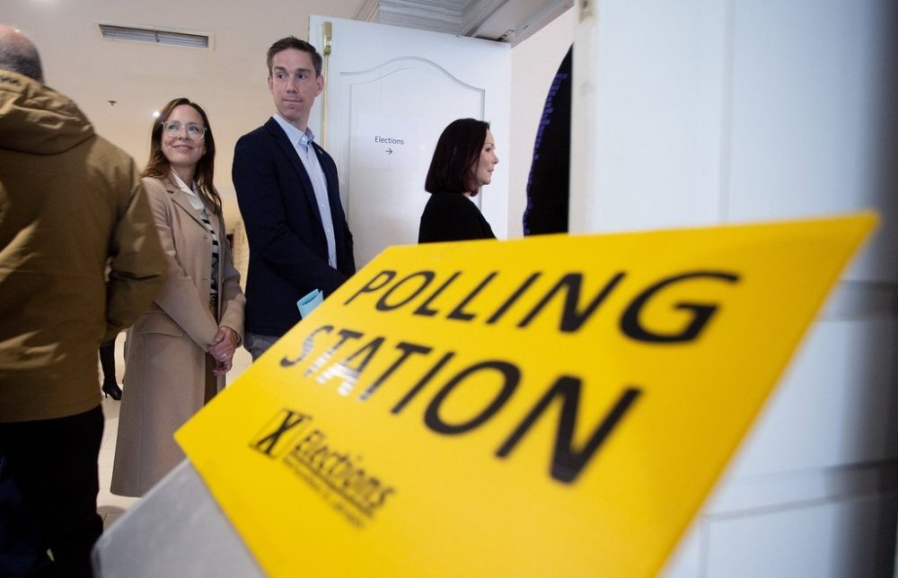 Liberal Leader John Hogan and his wife Gillian, wait in line to vote at the polling station in the Holiday Inn in St. John's N.L., on Tuesday, Oct. 14, 2025. THE CANADIAN PRESS/Paul Daly