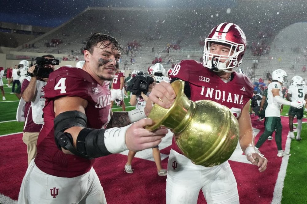 Indiana linebacker Aiden Fisher (4) and tight end James Bomba celebrate with the Old Brass Spittoon following an NCAA college football game against the Michigan State, Saturday, Oct. 18, 2025, in Bloomington, Ind. (AP Photo/AJ Mast)