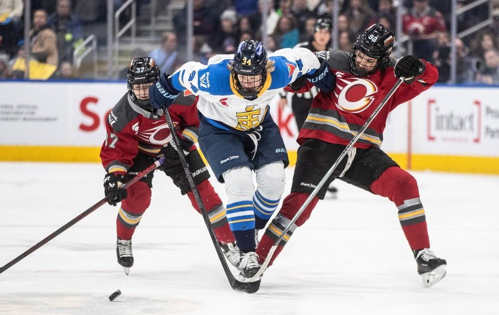 Toronto Sceptres' Hannah Miller (34) battled for the puck with Ottawa Charge's Rebecca Leslie (37) and Danielle Serdachny (92) during first period PWHL action in Edmonton on Sunday, Feb. 16, 2025. THE CANADIAN PRESS/Jason Franson