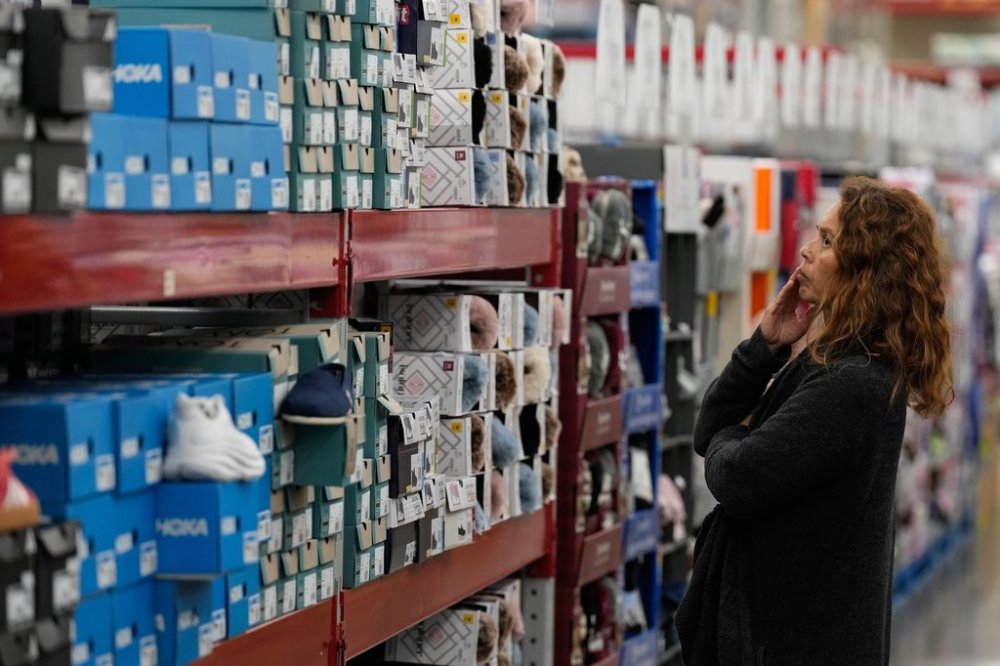 A woman looks at shoes at a Sam's Club, Wednesday, Sept. 24, 2025, in Bentonville, Ark. (AP Photo/Charlie Riedel)