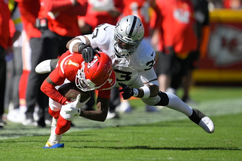 Kansas City Chiefs wide receiver Xavier Worthy (1) recovers a fumble by teammate Hollywood Brown Las Vegas Raiders linebacker Jamal Adams (33) during the second half of an NFL football game Sunday, Oct. 19, 2025, in Kansas City, Mo. (AP Photo/Reed Hoffmann)
