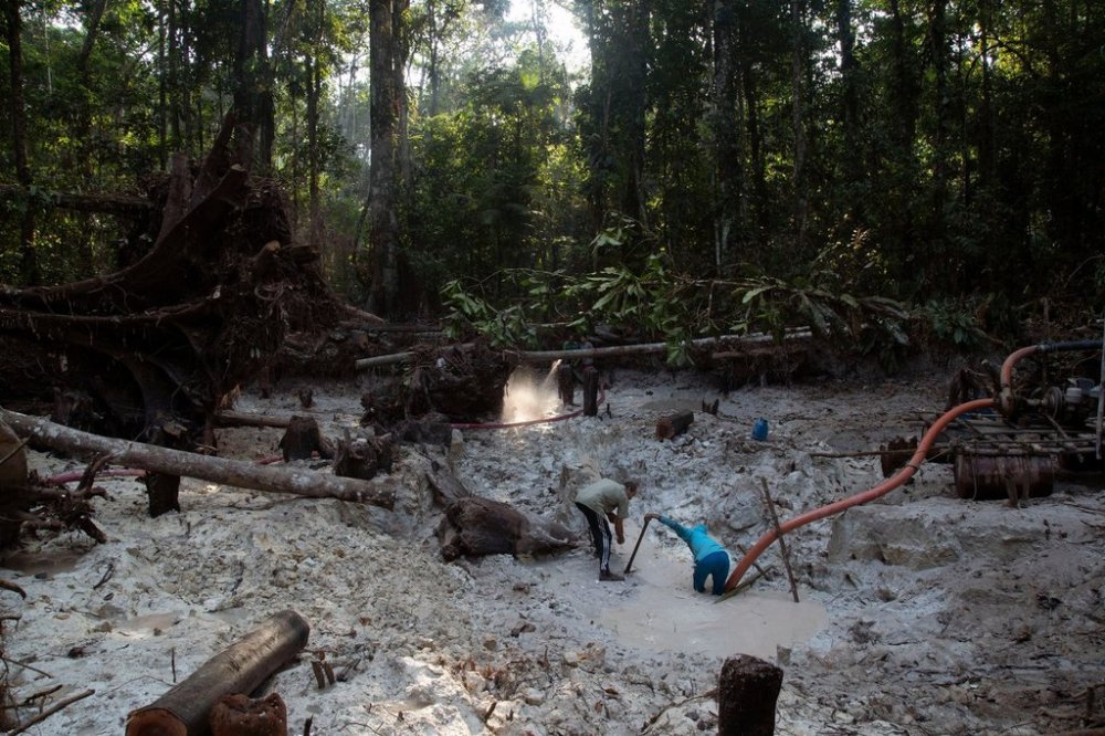 FILE - Men search for gold at an illegal gold mine in the Amazon jungle in the Itaituba area of Para state, Brazil, Friday, Aug. 21, 2020. (AP Photo/Lucas Dumphreys, File)