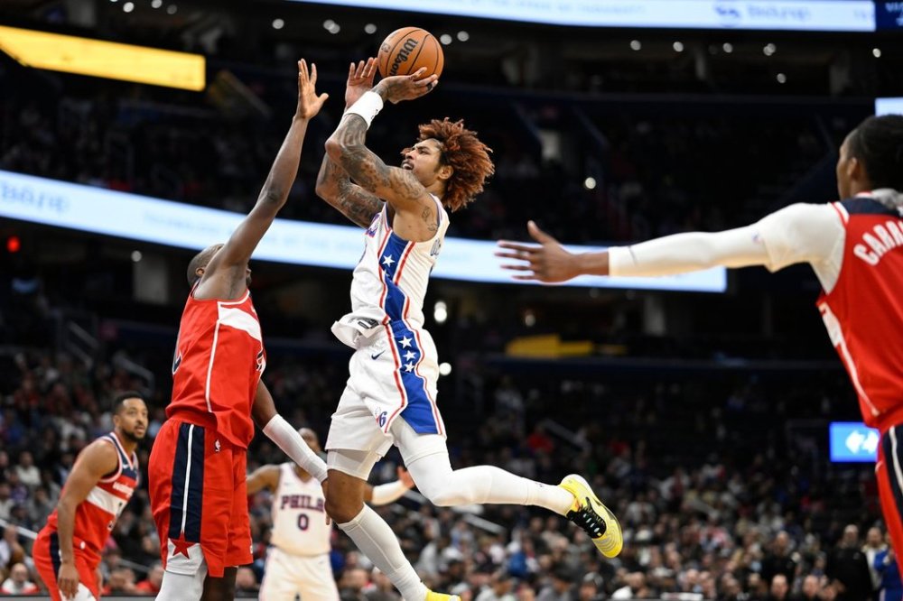Philadelphia 76ers guard Kelly Oubre Jr. scores a basket over Washington Wizards forward Khris Middleton during the second half of an NBA basketball game Tuesday, Oct. 28, 2025, in Washington. (AP Photo/John McDonnell)