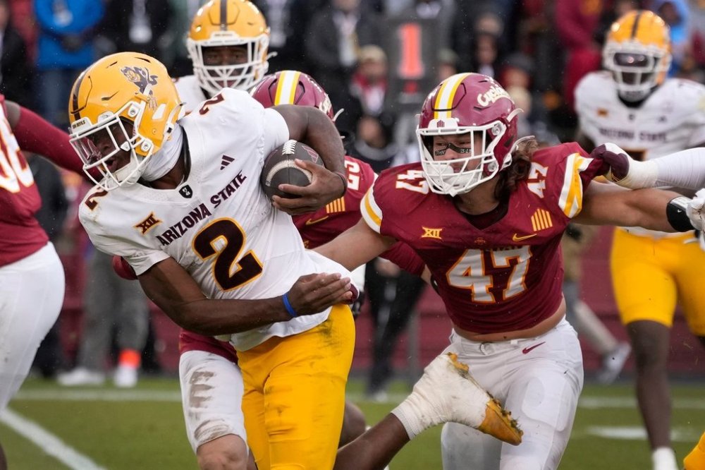 Arizona State quarterback Jeff Sims (2) runs from Iowa State linebacker Kooper Ebel (47) during the first half of an NCAA college football game, Saturday, Nov. 1, 2025, in Ames, Iowa. (AP Photo/Charlie Neibergall)