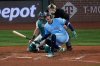 Toronto Blue Jays' George Springer falls after being hit by a pitch against the Seattle Mariners during the seventh inning in Game 5 of baseball's American League Championship Series, Friday, Oct. 17, 2025, in Seattle. (AP Photo/David J. Phillip)