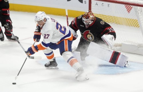 New York Islanders left wing Anders Lee (27) stick handles the puck in front of Ottawa Senators goaltender Linus Ullmark (35) during third period NHL action in Ottawa, Saturday, Oct. 18, 2025. THE CANADIAN PRESS/Adrian Wyld