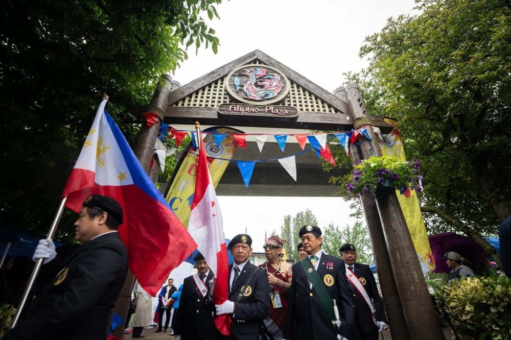 People march around Filipino Plaza before a memorial for the Filipino community's Lapu Lapu Day festival victims, in Vancouver, on Saturday, May 31, 2025. THE CANADIAN PRESS/Ethan Cairns