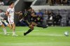 Los Angeles FC forward Jeremy Ebobisse (17) shoots as Toronto FC midfielder Alonso Coello, left, follows during the first half of an MLS soccer match, Wednesday, Oct. 8, 2025, in Los Angeles. (AP Photo/Jessie Alcheh)