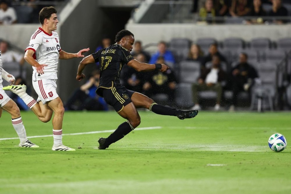 Los Angeles FC forward Jeremy Ebobisse (17) shoots as Toronto FC midfielder Alonso Coello, left, follows during the first half of an MLS soccer match, Wednesday, Oct. 8, 2025, in Los Angeles. (AP Photo/Jessie Alcheh)
